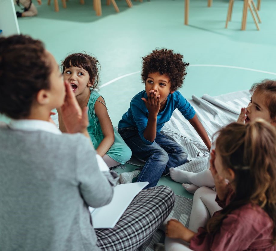 Educator engaging kids in social emotional learning at circle time
