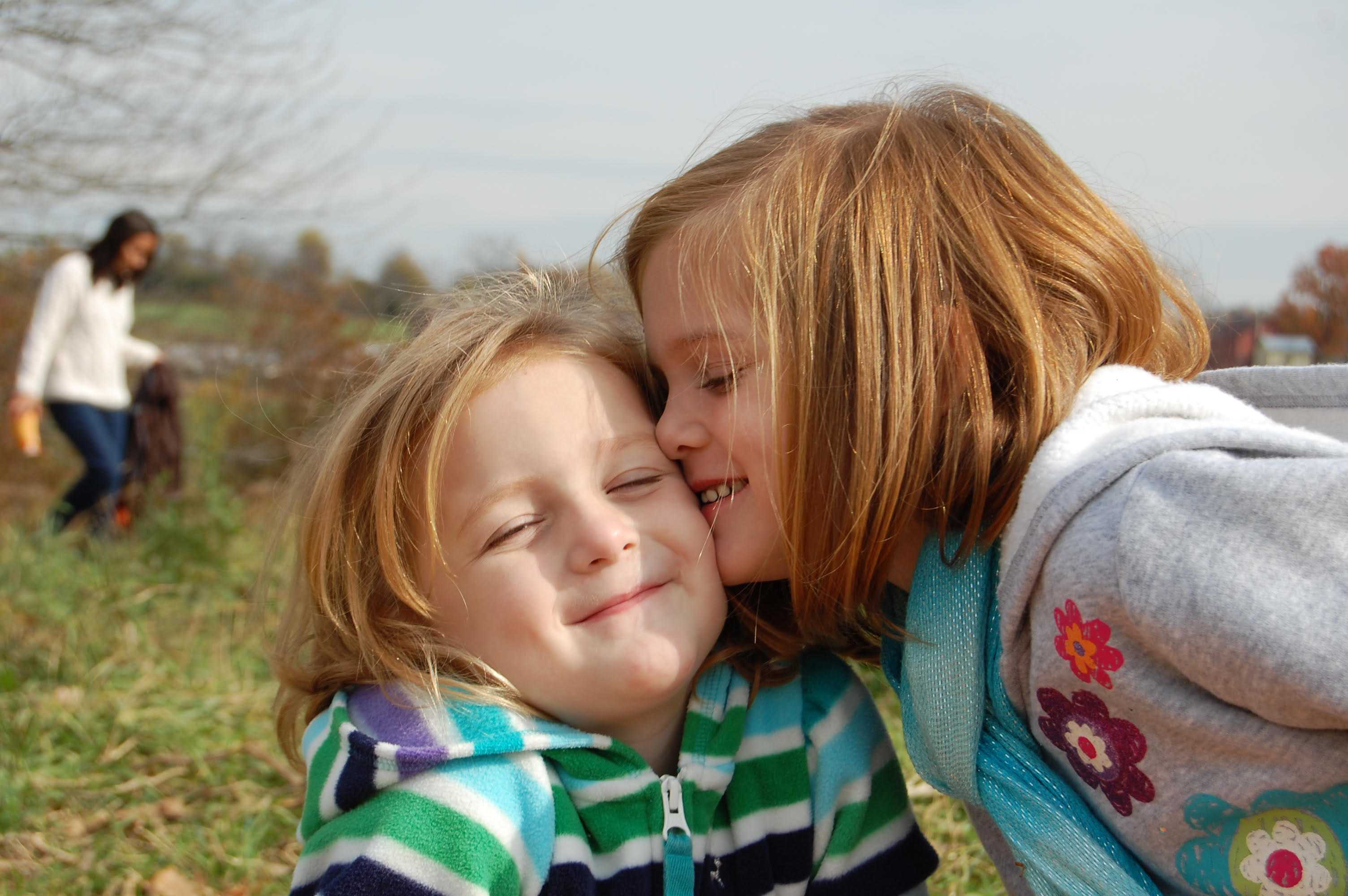 two little girls hugging and laughing